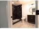 Contemporary bathroom with a marble-tiled shower, modern fixtures, and stylish black vanity at 69 N Hearn Rd, Ellenwood, GA 30294