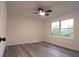 Bedroom features light gray flooring, a ceiling fan, and double windows creating a serene space at 69 N Hearn Rd, Ellenwood, GA 30294