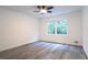 Bright bedroom features modern ceiling fan, hardwood floors, and double windows at 69 N Hearn Rd, Ellenwood, GA 30294