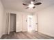 Well-lit bedroom with wood-look floors, ceiling fan, and closet at 69 N Hearn Rd, Ellenwood, GA 30294