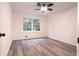 Bedroom featuring gray wood flooring and large window at 69 N Hearn Rd, Ellenwood, GA 30294