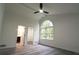 Bedroom featuring a vaulted ceiling, ceiling fan, and a large arched window at 69 N Hearn Rd, Ellenwood, GA 30294
