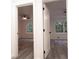 View of two bedrooms featuring ceiling fans and neutral walls through white paneled doorways at 69 N Hearn Rd, Ellenwood, GA 30294