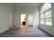 Spacious bedroom featuring gray wood-look flooring, white walls, and a large window at 69 N Hearn Rd, Ellenwood, GA 30294