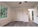 Well-lit bedroom with large window, closet, and wood-style flooring at 69 N Hearn Rd, Ellenwood, GA 30294