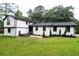 Charming two-story home featuring white brick and siding with a well-manicured lawn at 69 N Hearn Rd, Ellenwood, GA 30294
