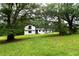 Charming two-story home with fresh exterior paint, lush landscaping, and a spacious front yard at 69 N Hearn Rd, Ellenwood, GA 30294