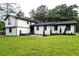 Beautifully renovated home features a fresh exterior, well-manicured lawn, and updated landscaping at 69 N Hearn Rd, Ellenwood, GA 30294