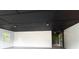 Spacious garage with a modern black ceiling and access to a bright, leafy outdoor area at 69 N Hearn Rd, Ellenwood, GA 30294