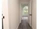 Bright hallway with wood-look floors leads to a room with a large arched window at 69 N Hearn Rd, Ellenwood, GA 30294