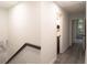 Hallway with stairs leads to a modern bathroom and bedroom with a large arched window at 69 N Hearn Rd, Ellenwood, GA 30294