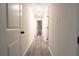 Hallway with hardwood floors and recessed lighting leading to various rooms at 69 N Hearn Rd, Ellenwood, GA 30294