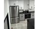 Bright kitchen with white cabinets, black countertops, stainless steel refrigerator, and stainless steel range at 69 N Hearn Rd, Ellenwood, GA 30294