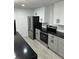 Bright kitchen with white cabinets, black countertops, stainless steel refrigerator, and stainless steel range at 69 N Hearn Rd, Ellenwood, GA 30294
