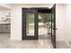 The kitchen is open to the outdoors, with black-framed glass doors, and contemporary countertops at 69 N Hearn Rd, Ellenwood, GA 30294