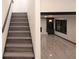 Staircase leading to a bright living room with fireplace and large window at 69 N Hearn Rd, Ellenwood, GA 30294