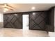 Large living room with geometric accent wall, tile floor, and ceiling fan at 69 N Hearn Rd, Ellenwood, GA 30294