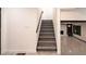 Bright, neutrally-decorated staircase leading to the living area featuring lovely tiled floors at 69 N Hearn Rd, Ellenwood, GA 30294