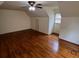 Spacious bedroom with hardwood floors, ceiling fan, and natural light from a window at 71 Southern Golf Ct, Fayetteville, GA 30215