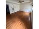 Large main bedroom with hardwood floors, tray ceiling, and two windows for ample light at 71 Southern Golf Ct, Fayetteville, GA 30215