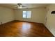Open bedroom with hard wood floors, large window and ceiling fan at 71 Southern Golf Ct, Fayetteville, GA 30215