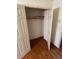 Walk-in closet with built-in shelving and hardwood floors, offering ample storage space at 71 Southern Golf Ct, Fayetteville, GA 30215