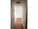 Hallway with hardwood floors leading to an unfinished attic room, showcasing the home's layout at 71 Southern Golf Ct, Fayetteville, GA 30215