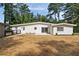 Backyard view of the modern white house featuring manicured landscaping at 974 Clydesdale Dr, Marietta, GA 30062