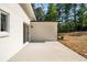 Backyard view of the modern white house featuring a patio and landscaped backyard at 974 Clydesdale Dr, Marietta, GA 30062