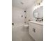 Modern bathroom with a tub, tiled shower, hexagon tile floors and a round mirror at 974 Clydesdale Dr, Marietta, GA 30062