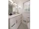 Modern bathroom features a white vanity, marble countertop, and a large mirror with stylish lighting at 974 Clydesdale Dr, Marietta, GA 30062