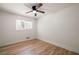 Bright bedroom with hardwood floors, neutral walls, ceiling fan, and a large window for natural light at 974 Clydesdale Dr, Marietta, GA 30062