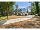 Exterior shot of a home with a large driveway, lush green landscaping, and an attached two-car garage at 974 Clydesdale Dr, Marietta, GA 30062