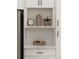 Bright kitchen features white cabinets, tile backsplash, and decorative shelf at 974 Clydesdale Dr, Marietta, GA 30062