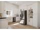 Bright kitchen features white cabinets, stainless steel appliances, and light wood floors at 974 Clydesdale Dr, Marietta, GA 30062