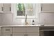 Bright kitchen sink features white cabinets, subway tile backsplash, and bronze fixtures at 974 Clydesdale Dr, Marietta, GA 30062