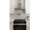 Bright kitchen features stainless steel range hood and pot filler at 974 Clydesdale Dr, Marietta, GA 30062