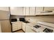 Compact kitchen with white cabinetry, stainless steel appliances, and a functional layout at 1225 Church St # G, Decatur, GA 30030