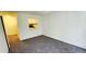 Cozy living room featuring neutral walls, plush carpet, and a convenient pass-through to the kitchen at 1225 Church St # G, Decatur, GA 30030