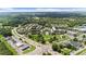Take in the aerial view of the community park with lush green spaces, sidewalks and nearby retail at 189 Azalea Chase Dr, Suwanee, GA 30024