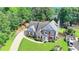 An aerial view of a brick home featuring a long driveway and private backyard at 189 Azalea Chase Dr, Suwanee, GA 30024