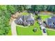 Aerial view of brick home, mature trees, and beautiful backyard landscaping at 189 Azalea Chase Dr, Suwanee, GA 30024