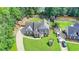 A high aerial view of a brick home with backyard play area and established landscaping at 189 Azalea Chase Dr, Suwanee, GA 30024