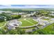 Beautiful aerial view of a green community park with manicured lawns, walking paths and water feature at 189 Azalea Chase Dr, Suwanee, GA 30024