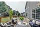 Inviting stone patio with stylish outdoor seating and lush landscaping, perfect for entertaining at 189 Azalea Chase Dr, Suwanee, GA 30024