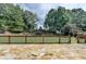 Spacious backyard with well-maintained lawn, mature trees, and a charming play area at 189 Azalea Chase Dr, Suwanee, GA 30024