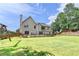 Picturesque view of the home's backyard, highlighting the lush lawn and wooded surroundings at 189 Azalea Chase Dr, Suwanee, GA 30024