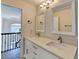 This modern bathroom features a double vanity with marble countertops and elegant lighting at 189 Azalea Chase Dr, Suwanee, GA 30024