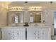 Bright bathroom featuring double vanity with elegant mirrors and lighting fixtures at 189 Azalea Chase Dr, Suwanee, GA 30024