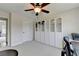 This bedroom features built-in storage, a ceiling fan, and plush carpet at 189 Azalea Chase Dr, Suwanee, GA 30024